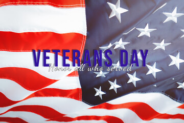Fototapeta na wymiar Veterans day. Honoring all who served. American flag waving in the wind.