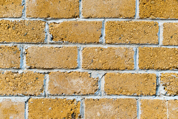Fototapeta premium background from a miniature houses in a city park, yellow brick wall and windows