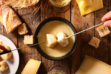 cheese fondue with wine and baguett