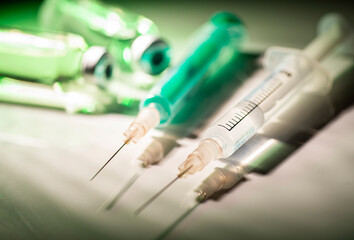 Two syringes and vials with vaccine