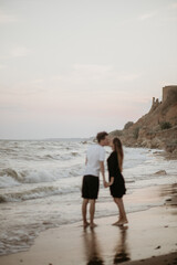 young couple kissing by the sea