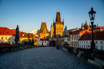 Charles bridge with Lesser town bridge tower, statue and historical building around.