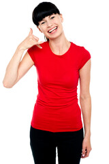 Cheerful brunette gesturing a mock call