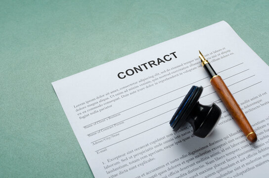 Closeup of pen, stamp and contract form on the blue office workplace