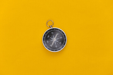 Compass on a yellow background. Top view. Minimalism travel concept. Flat lay © splitov27