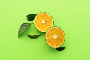 fresh mandarin fruits on green background