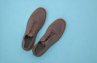 Men's shoes on blue background. Top view
