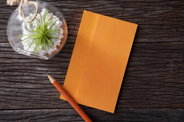 Pink memo note pad and pink colored pencil on pink background.