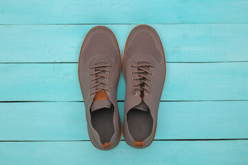 Men's shoes on blue wooden background. Top view