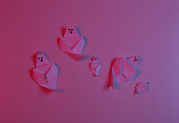 Paper Origami ghosts in red blue neon light. Halloween theme