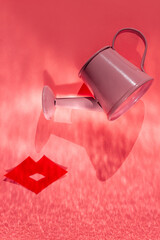 Pink watering can and red lips on pastel background flat lay with shadow. Creative minimalism pop art composition. Valentines day vertical banner minimal style. Romantic love greeting card design idea © KawaiiS