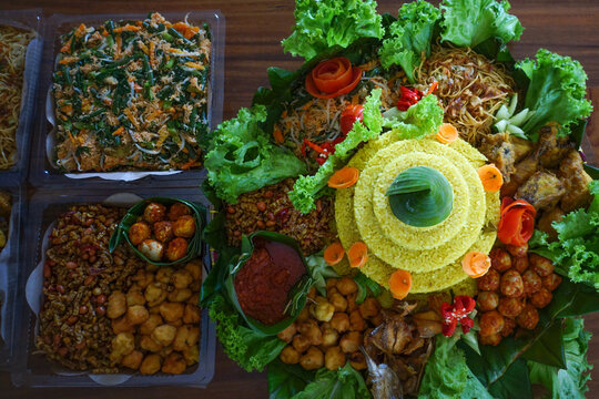 Nasi Tumpeng is a festive Indonesian rice dish with various side dishes