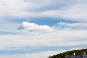 Clouds over the city. Blue sky with cloud closeup