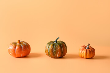 Thanksgiving day or Halloween different pumpkins harvest on orange. Space for text.