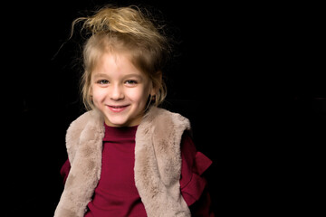 Close Up View of Cute Smiling Blonde Girl Posing on Black Background.