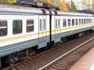 Fototapeta premium train cars on railway platform in Moscow region on autumn evening