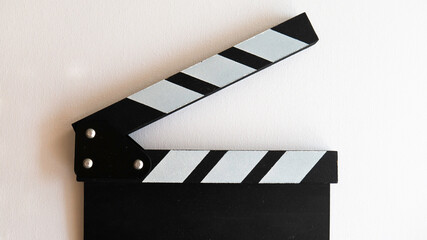 Close up of a wooden black clapperboard.