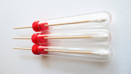 Medical swab for sampling on a white background.