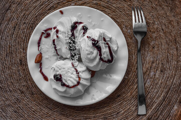 Appetizing snack for breakfast - white marshmallows on a wooden table
