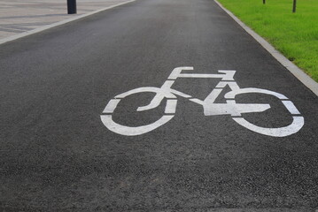 Fototapeta premium White drawn bike sign on the asphalt. Separate cycle path for cyclists, environmentally friendly urban transport for Sport . Dnepropetrovsk, Dnipro city, Ukraine