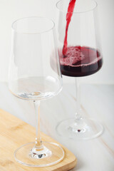 Red wine pouring to a white glass