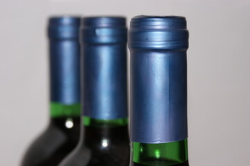 Redwinebottle with a blue cap