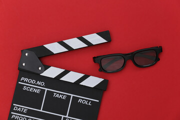 Film clapper board and 3d glasses on red background. Cinema industry, entertainment. Top view