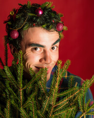 attractive man in a plaid shirt on a red background hair like a christmas tree christmas mood copyspace
