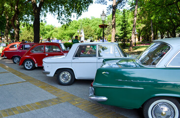 Fototapeta premium The unique details of exterior of the luxury retro car - oldtimer - the car headlights, shiny car hood and wing, the windshield, engine and wheel