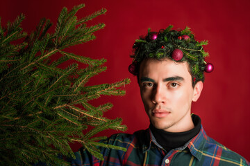 attractive man in a plaid shirt on a red background hair like a christmas tree christmas mood copyspace