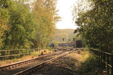 Fototapeta na wymiar Closeup shot of a railroad and a field 