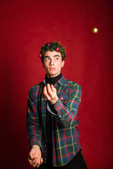 attractive man in a plaid shirt on a red background hair like a christmas tree christmas mood copyspace
