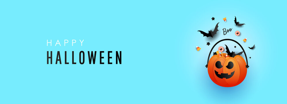 Halloween pumpkin decorations with striped candy and a bat on a blue background