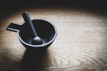 Metal spice crusher on wood