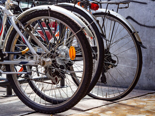 Fototapeta na wymiar Bike parking close-up of rear tyresi