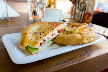 Delicious fast food breakfast in Serbia - ham, lettuce, onion and cheese in the traditional bun, somun bread