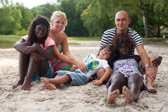 Multicultural Family On The Beach