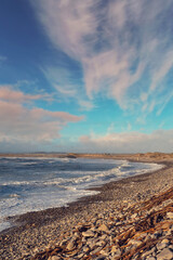 View on Atlantic ocean, Strandhill beach, county Sligo Ireland. Waves and blue cloudy sky
