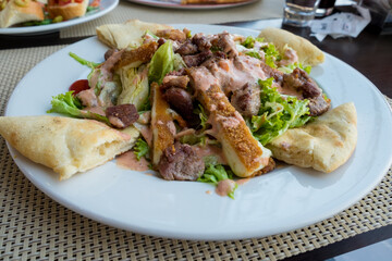 Meat caesar - beef salad with toasted bread, cherry tomatoes and cheese sauce