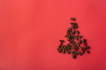 Christmas tree made of cones on a red background