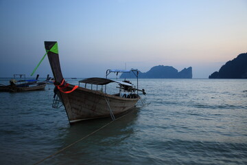 View of Tonsai bay with longtail boats and  rocks during sunset in Phi Phi island,  Phuket, Krabi...