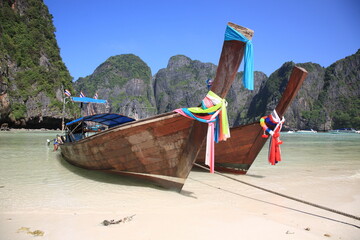 Close up view of Longtail boats sit at the beautiful Maya Bay in Phi Phi island,  krabi province, Thailand 