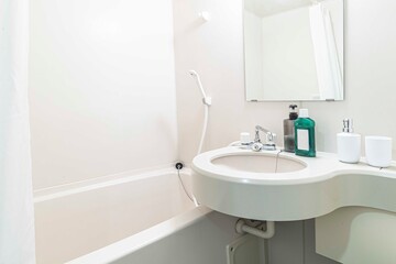 Naklejka na ściany i meble Small bathtub and shower in the bathroom at the hotel.