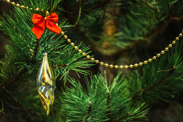 christmas background with a long christmas toy on a christmas tree branch - 383808975