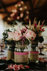 Handmade centerpiece with recycled materials and natural flowers. Pink roses