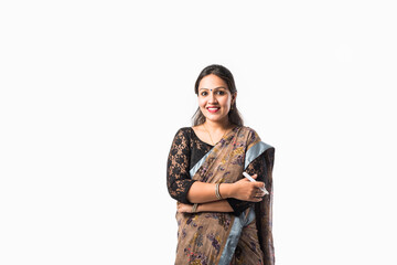 Portrait of asian Indian lady teacher in saree stands against writing board conducting online class