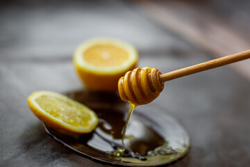 wooden spoon of honey with lemon