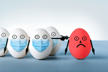 Eggs in medical masks condemn a red egg without a protective mask. Concept an irresponsible person ignores public rules during a viral disease epidemic.