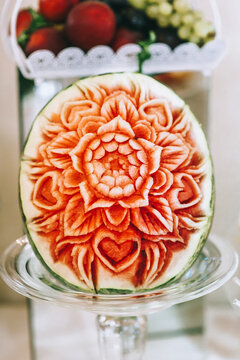 Watermelon carving art. Carved beautiful flower on a large watermelon to serve on a sweet table.