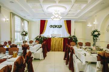 Banquet tables are served for guests in the elegantly decorated halls of the restaurant.
